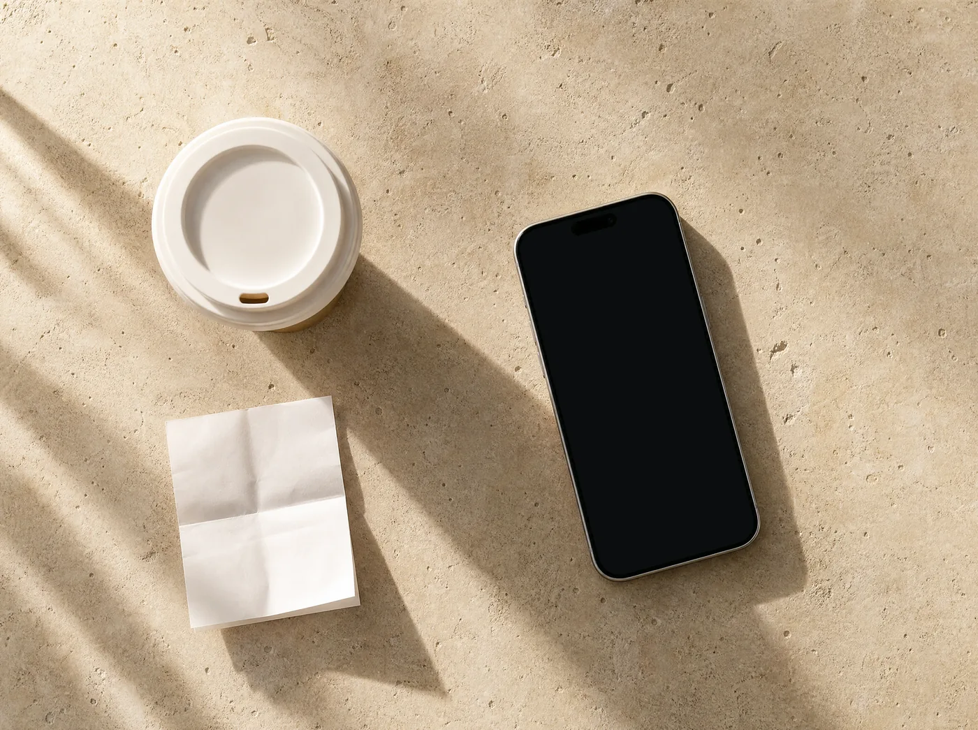 An iPhone on a café table next to a cup of coffee, showing the calculation.