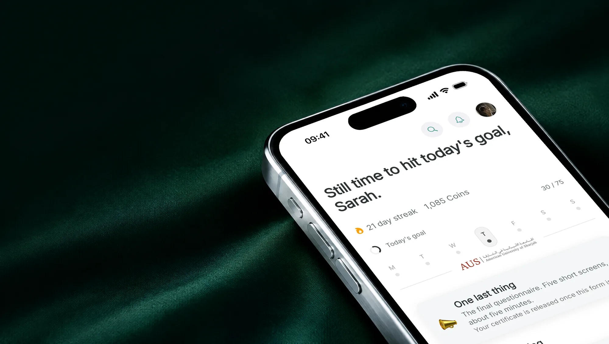 An iPhone lying on emerald satin, the Nayra app on its screen.